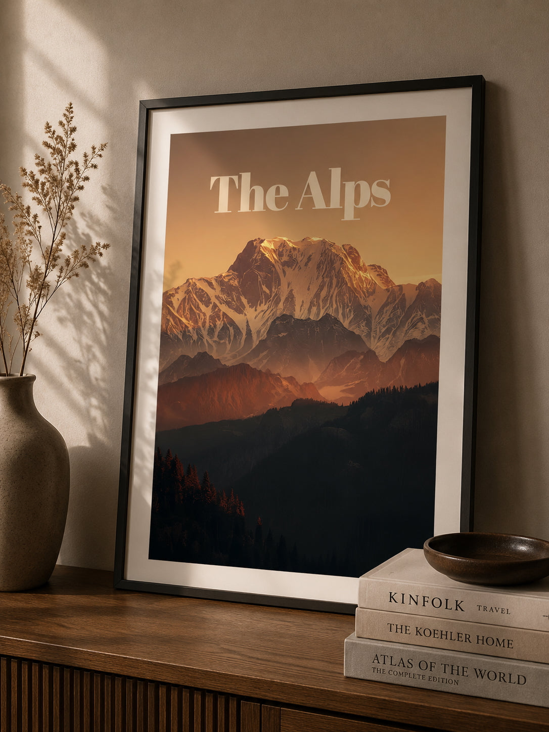 The Alps Travel Poster displayed on a desk.